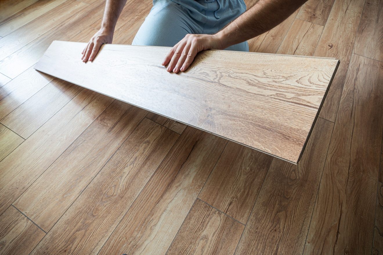 replacement-parquet-floor-man-laying-flooring-home